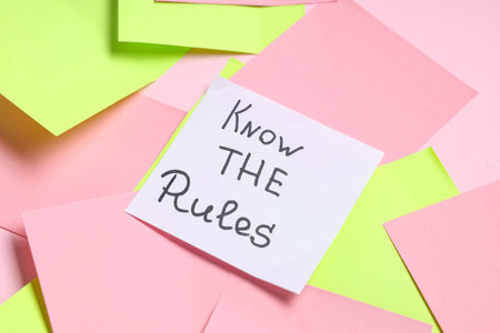 Sticky notes with text KNOW THE RULES on pink backgroundの写真素材