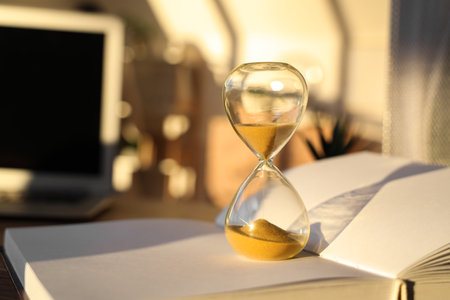 Hourglass on book in office, closeupの写真素材