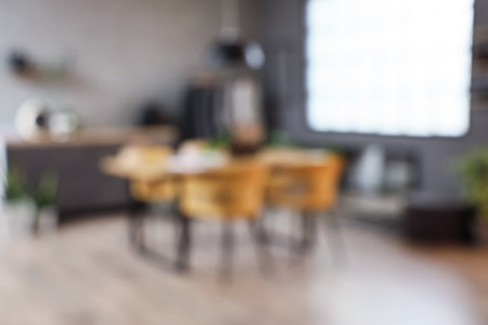 Blurred view of clothing store office with table, rack and counters