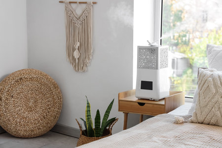 Modern air humidifier on table in bedroomの写真素材