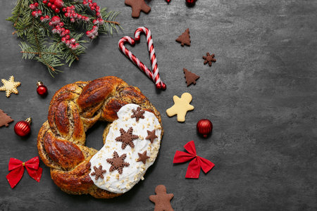 Composition with tasty Christmas pastry wreath, decorations and cookies on dark backgroundの写真素材