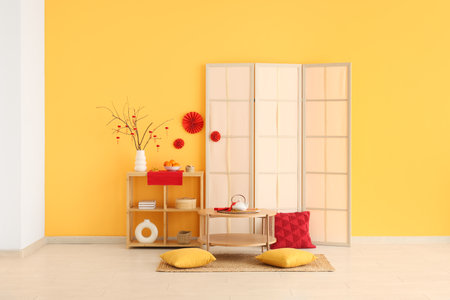 Interior of living room decorated for Chinese New Year with table, shelf unit and folding screenの写真素材