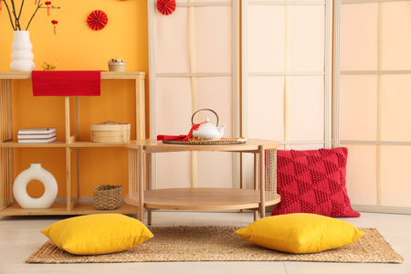 Interior of living room decorated for Chinese New Year with table, shelf unit and folding screenの写真素材