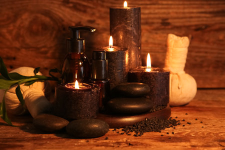 Beautiful spa composition with spa accessories and cosmetic products on dark wooden backgroundの写真素材