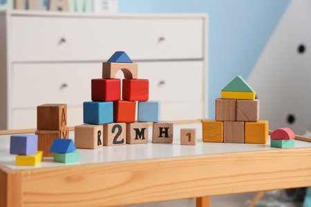 Wooden cubes on table in children's room, closeupの写真素材