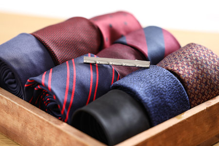 Box with men's neckties and clip on table, closeupの写真素材