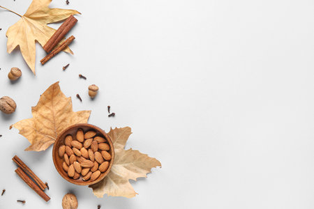 Composition with almond nuts, spices, acorns and fallen leaves on gray backgroundの写真素材