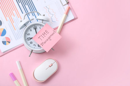Sticky note with text TIME MANAGEMENT, alarm clock, computer mouse and financial documents on pink...
