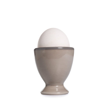 Ceramic holder with chicken egg isolated on white backgroundの写真素材
