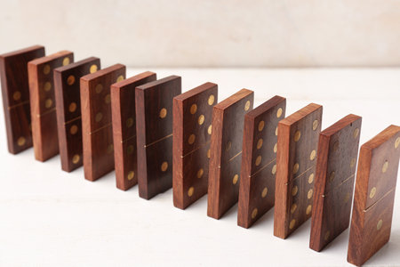 Many dominos blocks on white wooden tableの写真素材