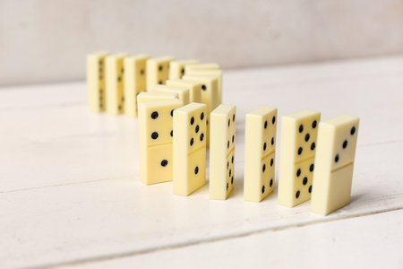 Many dominos blocks on white wooden tableの写真素材