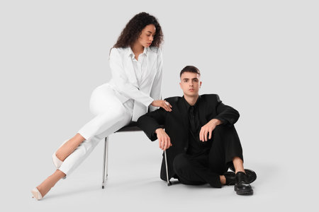 Young couple sitting on white background. Yin Yang conceptの写真素材