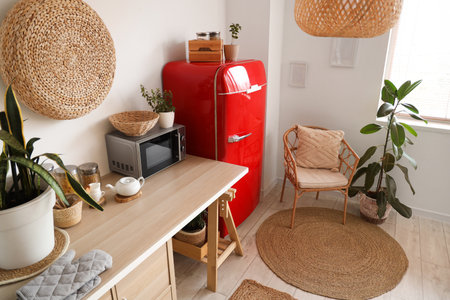 Interior of stylish kitchen with microwave oven, houseplants and modern refrigeratorの写真素材