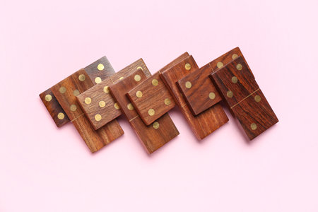 Wooden dominos blocks on pink backgroundの写真素材