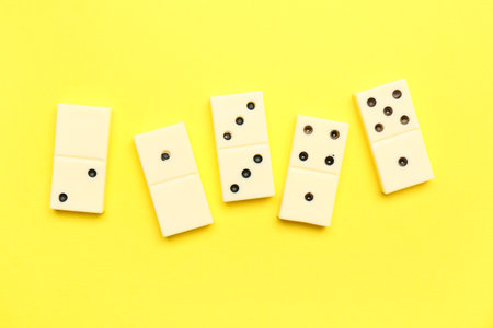 White dominos blocks on yellow backgroundの写真素材