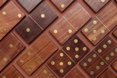 Many wooden dominos blocks on brown backgroundの写真素材