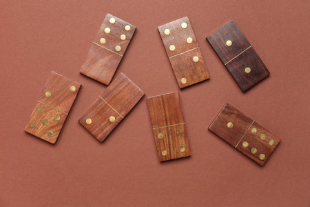 Many wooden dominos blocks on brown background