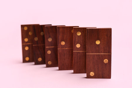 Wooden dominos blocks on pink backgroundの写真素材