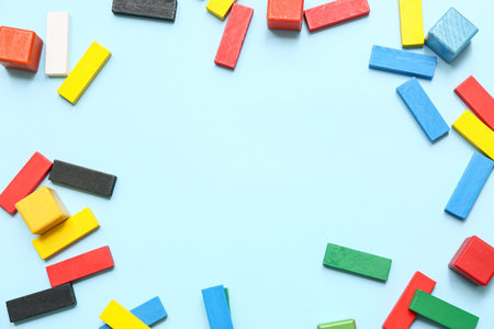 Frame made of colorful building blocks on color background