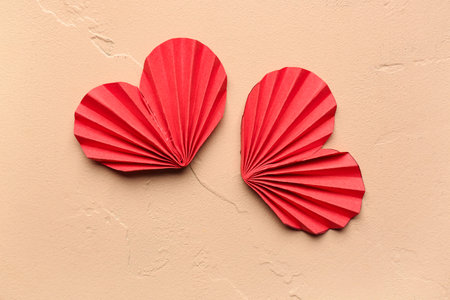 Red paper hearts on beige background. Valentine's Day celebration