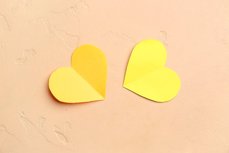 Yellow paper hearts on beige background. Valentine's Day celebrationの写真素材