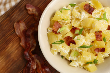 Bowl of tasty potato salad with green onion and bacon, closeupの写真素材