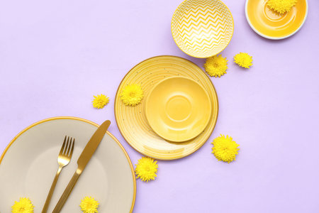 Stylish table setting with beautiful dandelion flowers on lilac background