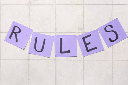 Papers with word RULES on light tile backgroundの写真素材