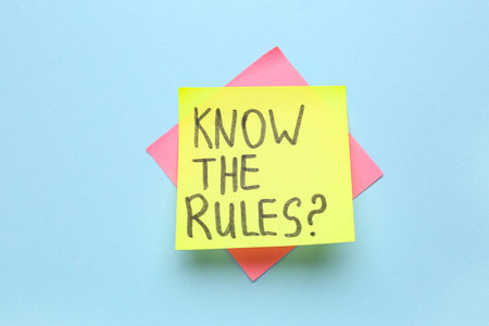Sticky notes with text KNOW THE RULES? on blue backgroundの写真素材