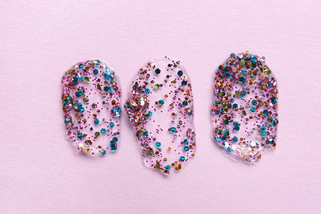 Color glitter strokes on lilac background