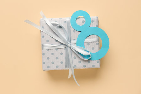 Paper figure 8 with gift box on beige background. Happy Women's Dayの写真素材