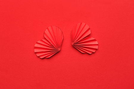 Red paper hearts on color background. Valentine's Day celebration