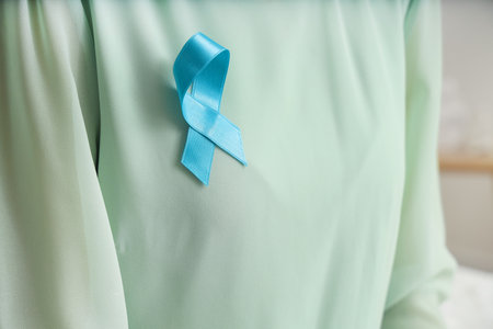 Young woman with turquoise ribbon at home, closeup. Cervical Health Awareness Monthの写真素材