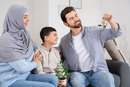 Happy Muslim family with key in their new houseの写真素材