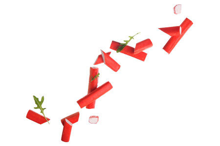 Tasty crab sticks and arugula leaves flying on white backgroundの写真素材