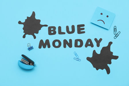 Office stationery with drawn sad face, blots and text BLUE MONDAYの写真素材