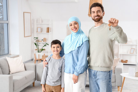 Happy Muslim family with key in their new houseの写真素材