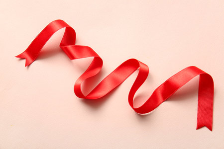 Beautiful red ribbon on pink backgroundの写真素材