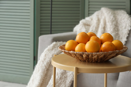 Plate with oranges on table in living room, closeupの写真素材