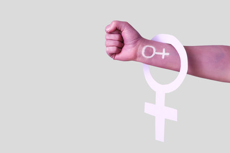 Female painted hand with symbols of woman on light background. Feminism conceptの写真素材