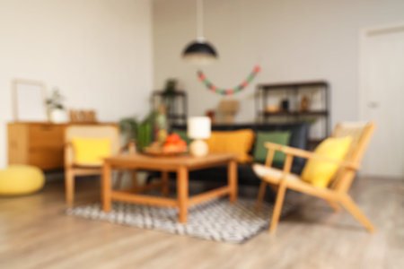 Blurred view of living room decorated for Kwanzaa celebration with sofa, armchairs and tableの写真素材