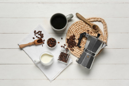 Geyser coffee maker with cup, jug of milk and beans on white wooden backgroundの写真素材