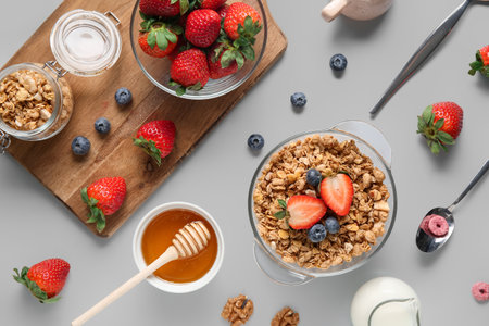Bowls with healthy granola and berries on gray backgroundの写真素材