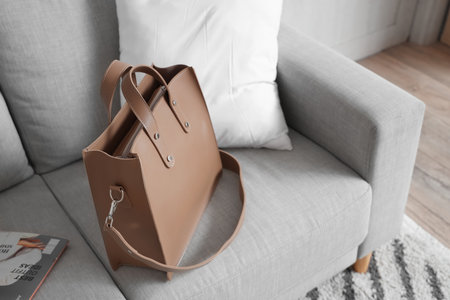 Stylish bag on gray sofa in hallwayの写真素材