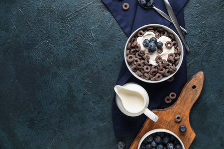 Bowl with cereal rings and milk on blue grunge backgroundの写真素材