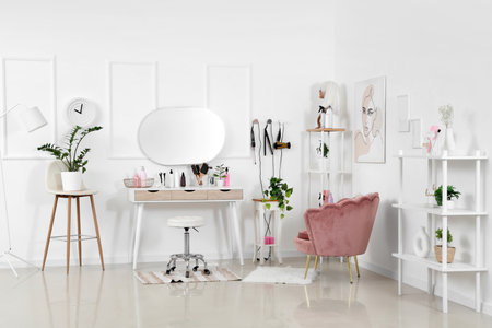 Interior of hairdressing salon with table, armchair and shelf unitsの写真素材