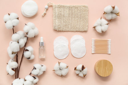 Composition with bath supplies, cosmetic products and beautiful cotton flowers on color backgroundの写真素材