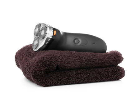 Electric shaver with towel on white backgroundの写真素材