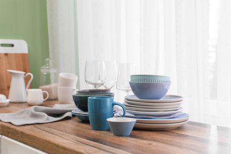 Clean blue dishes on counter near window in kitchenの写真素材