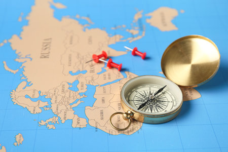 Compass with pins on map, closeup. Itinerary conceptの写真素材